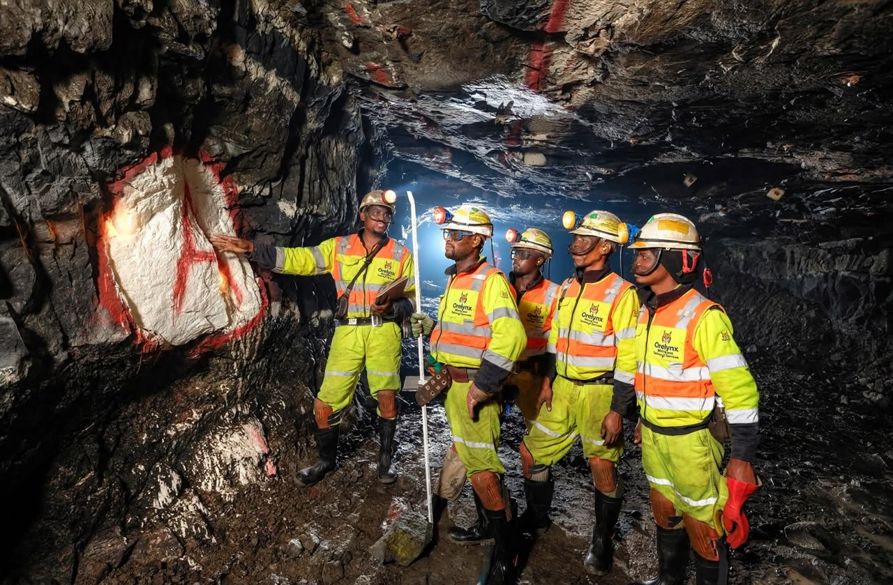 ORELYNX mining engineers inspecting a marked rock face underground