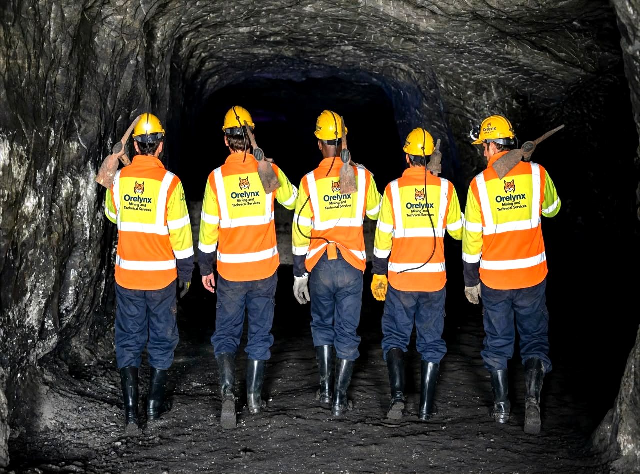 ORELYNX crew walking into an underground mine tunnel